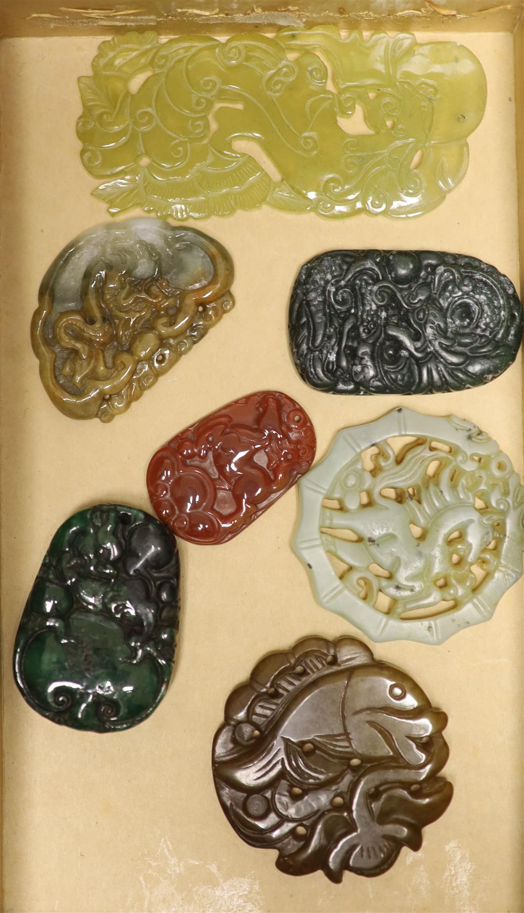 Seven Chinese jadeite and hardstone plaques, widest 9cm